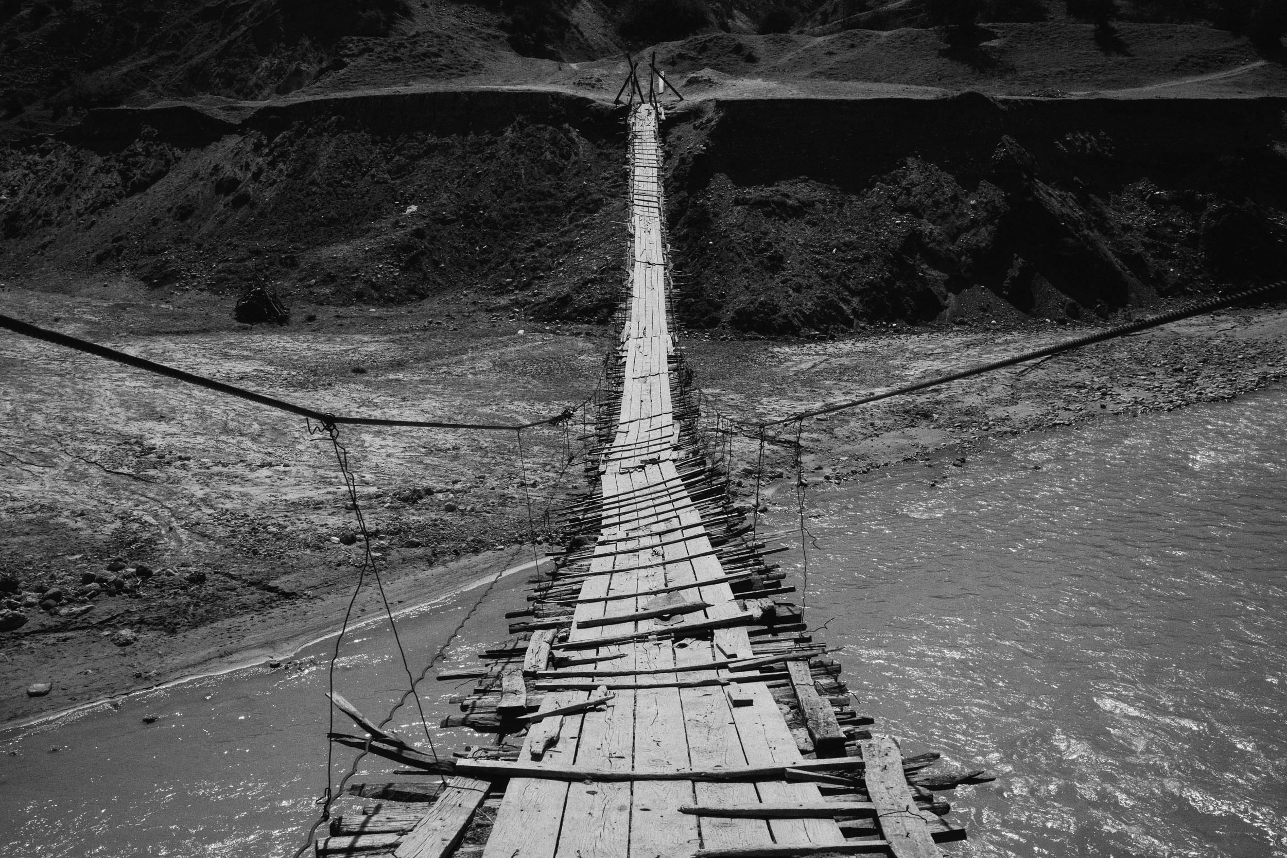 Rickety wooden bridge across a river